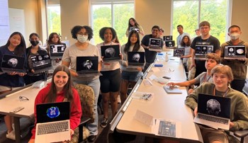 Students hold scans of their brains at Auburn University Brain Camp