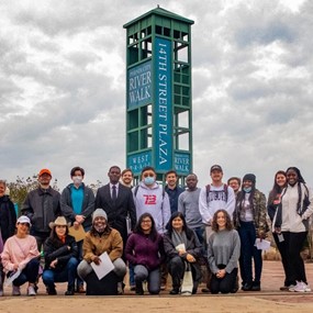 Group of people standing in front of a tower