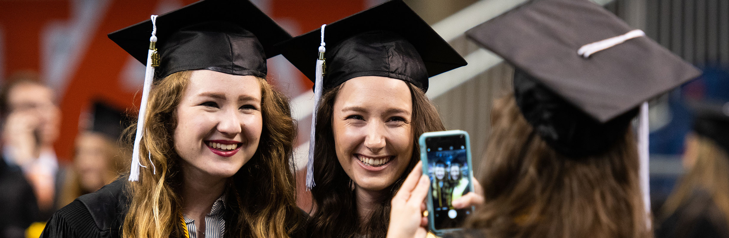 students taking pictures at graduation