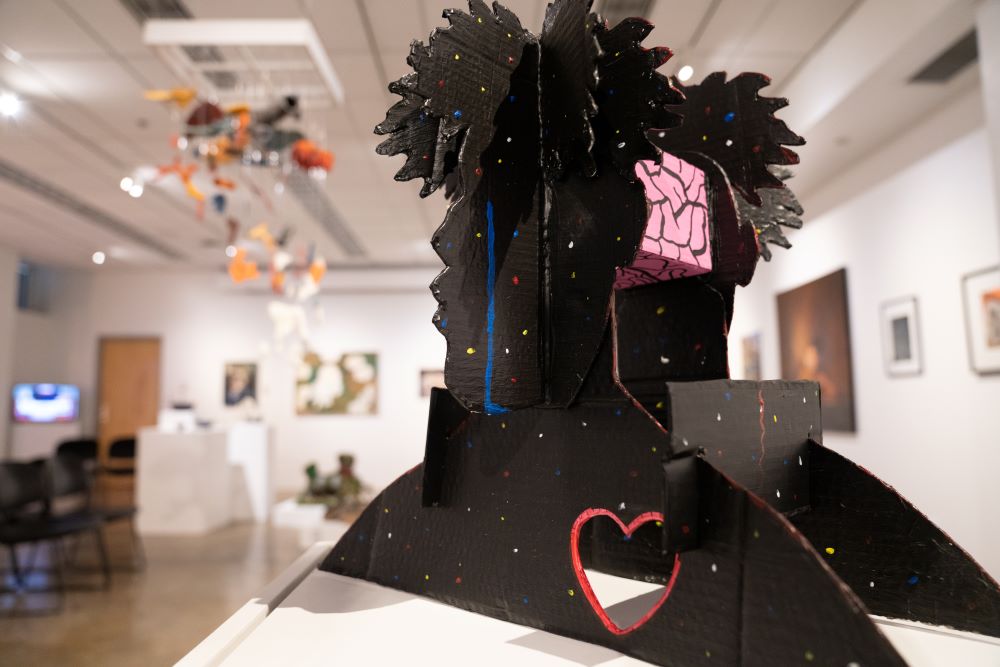 Colorful cardboard and acrylic sculpture of person with brain and heart
