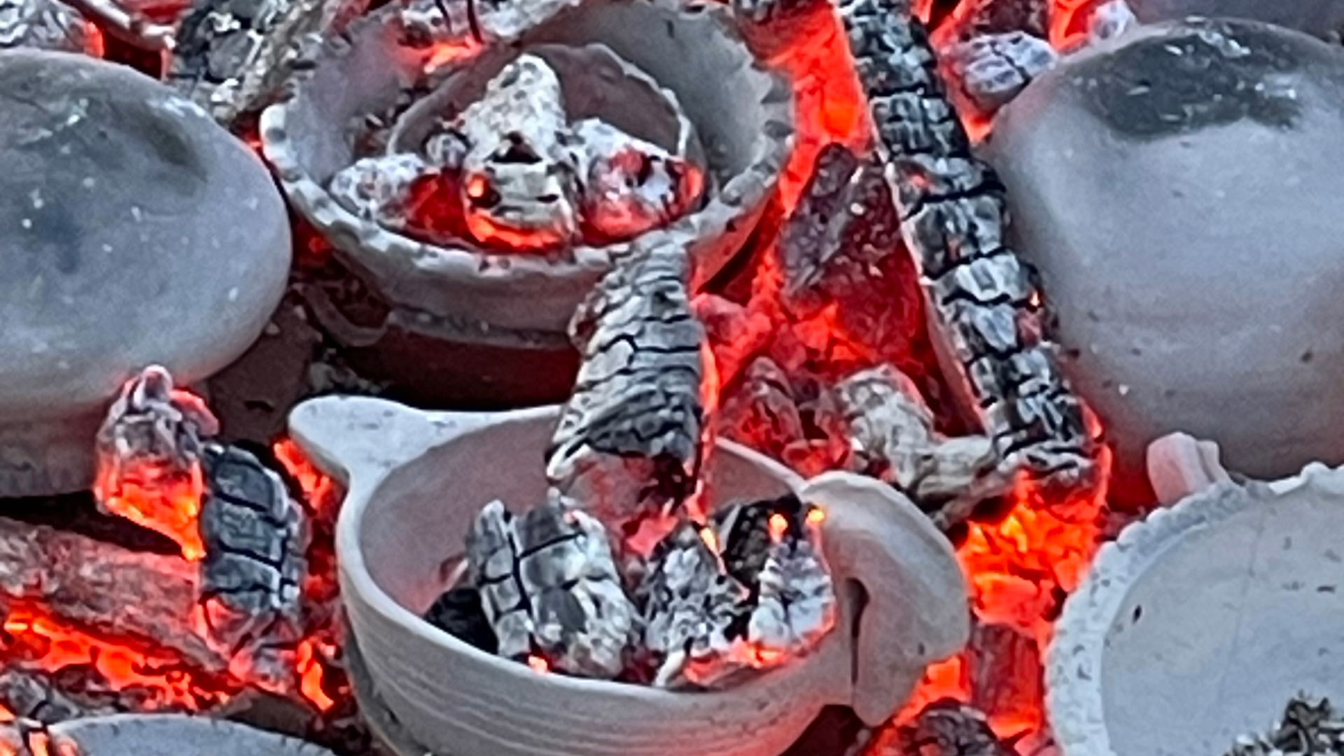 Image of clay pots with hot coals