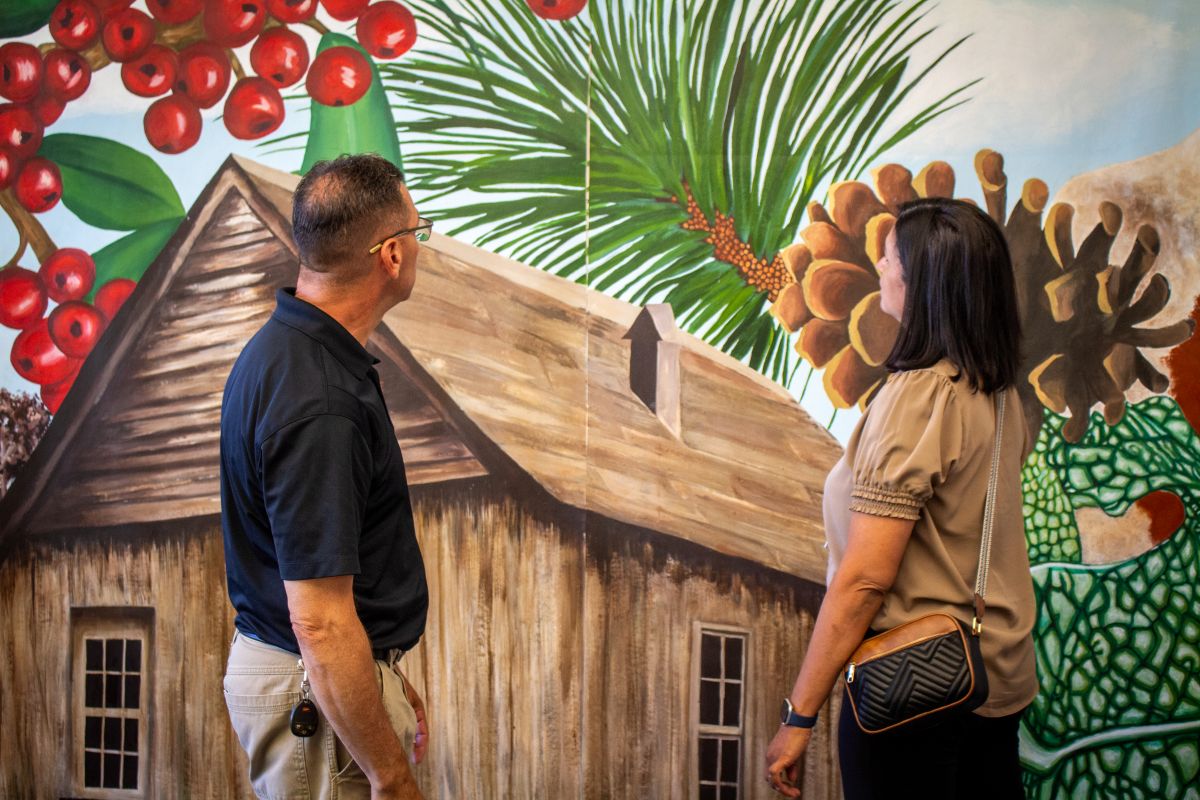 Clayton Coon and Brandy Chunn viewing pieces of the mural project inside Biggin Hall