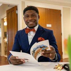 Terrance Vickerstaff holding Betsey Scott Harper book