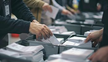 Poll workers sorting ballots