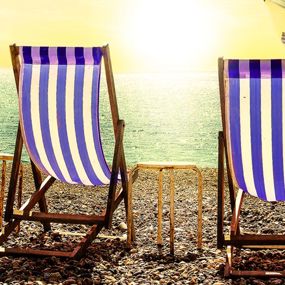 Two beach chairs facing the ocean