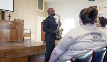 Khari Allen Lee plays the saxophone in the Tutwiler Prison chapel