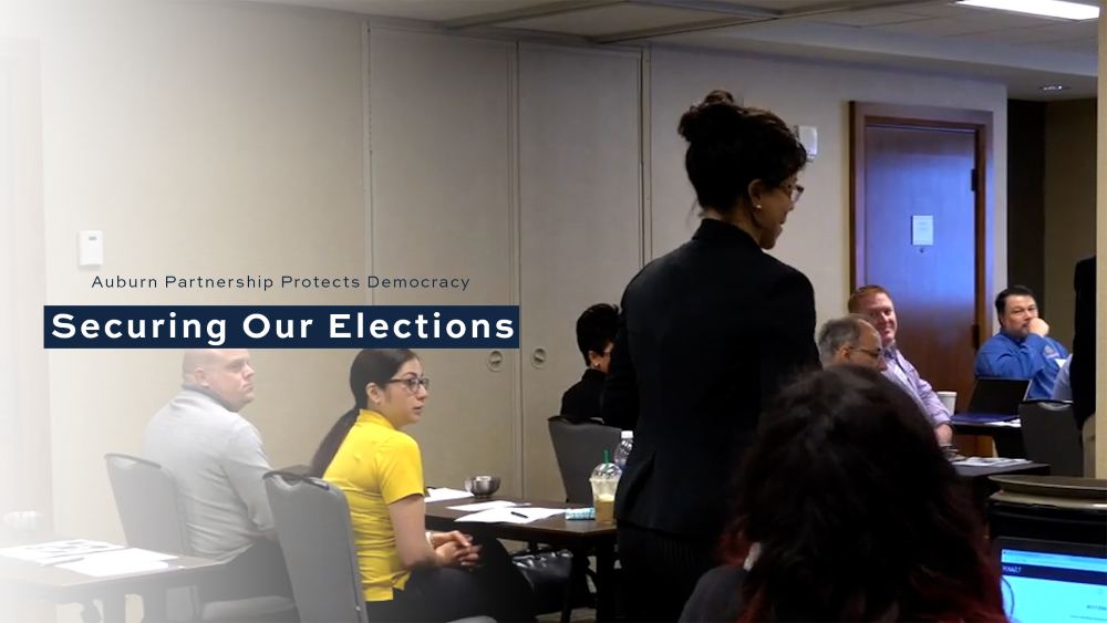 An instructor leads a CERA class of election administrators with text "Auburn partnership protects democracy, securing our elections"