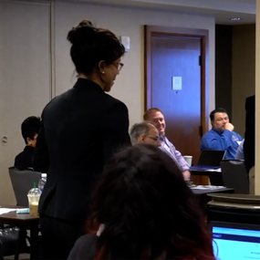 An instructor leads a CERA class of election administrators with text "Auburn partnership protects democracy, securing our elections"