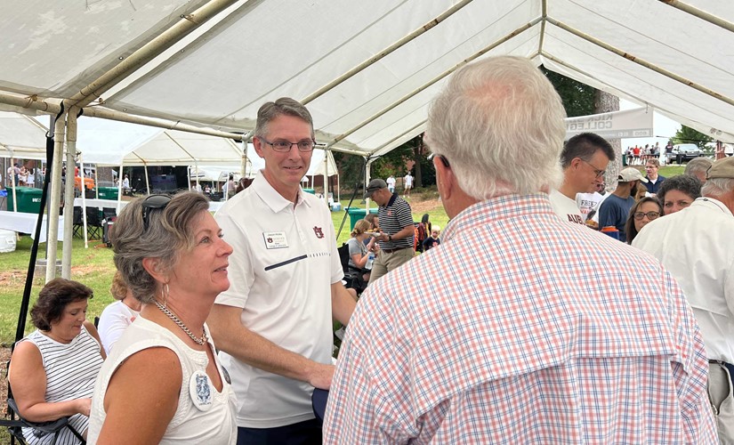 Dean Hicks with faculty and alumni at tailgate