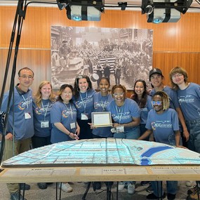 Researchers stand at Selma exhibit with People's Choice Award
