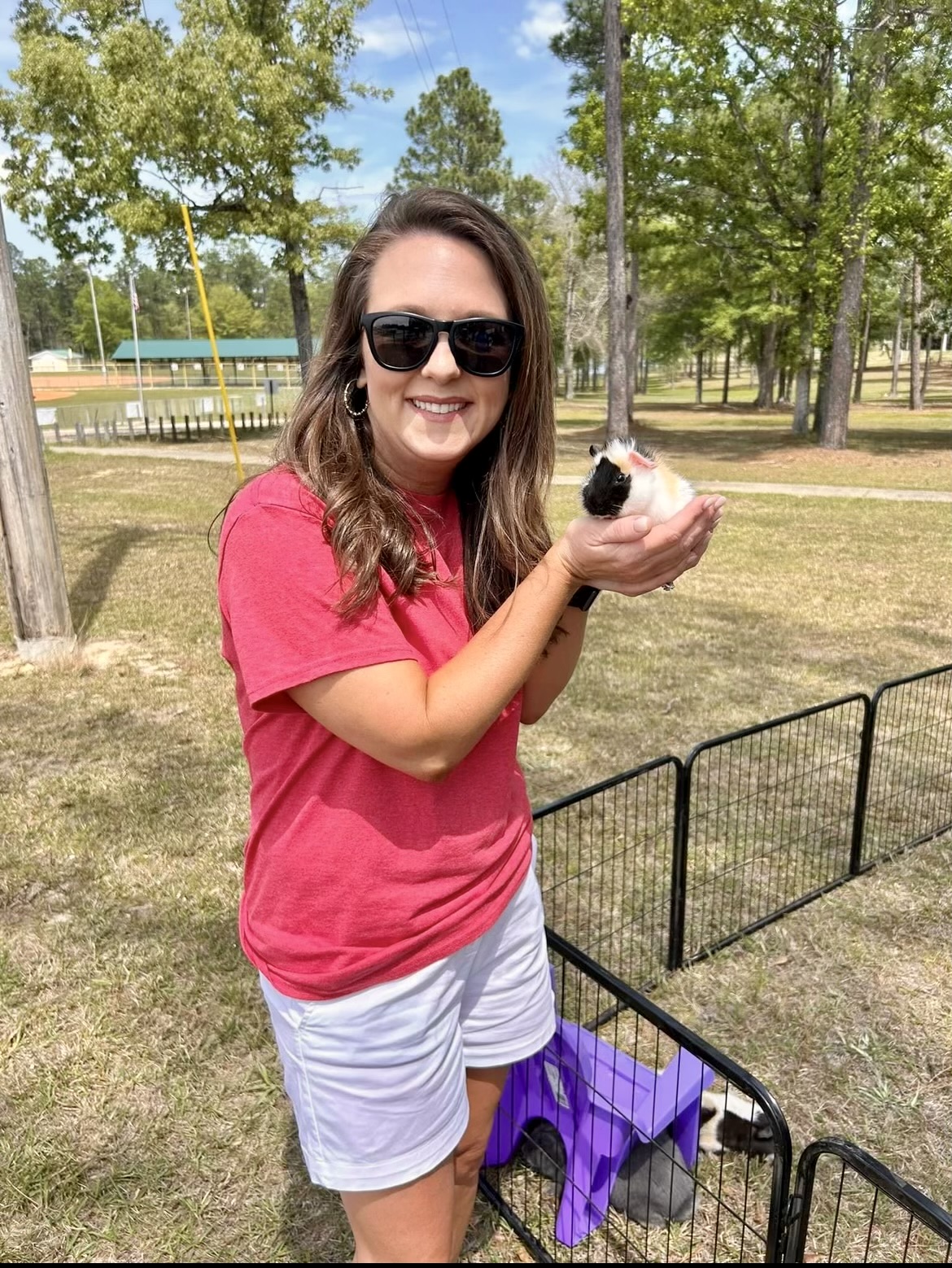 Crimson Tarver holds a guinea pig from the Brown Farm at the spring Touch a Truck event.