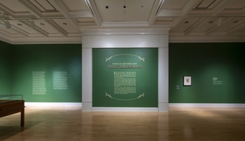 Title wall of Radical Naturalism: Lyric Birdscapes. Walls are an emerald green with light gold text and surrounding leaf graphic elements and white trim