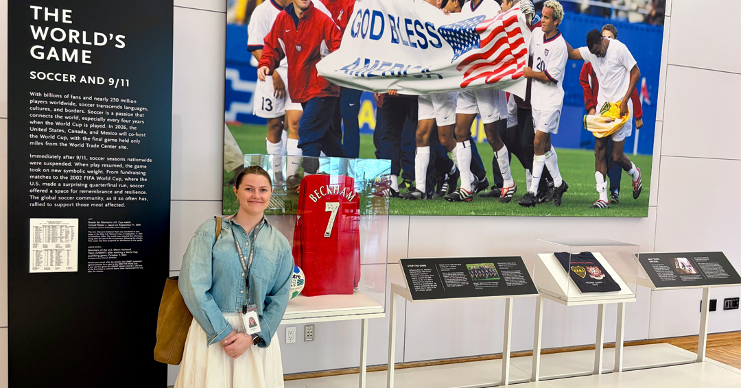 Brucie Porter standing beside the soccer exhibit at the National September 11 Memorial and Museum