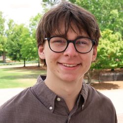 Will Lewis smiling for a photo on campus