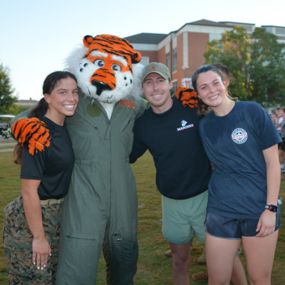 Aubie posing for a photo with student veterans