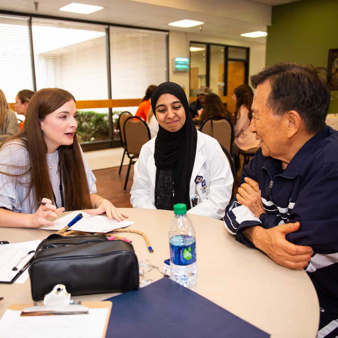 students around table with client