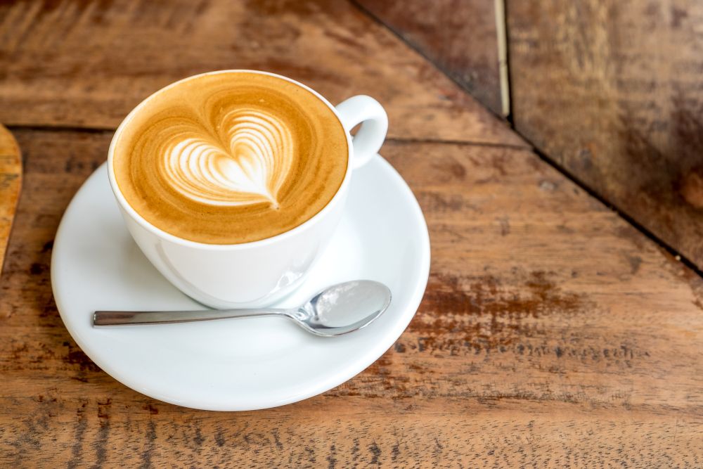 A latte with foam shaped like a heart