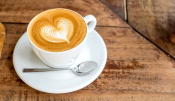 A latte with foam shaped like a heart