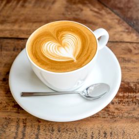 A latte with foam shaped like a heart