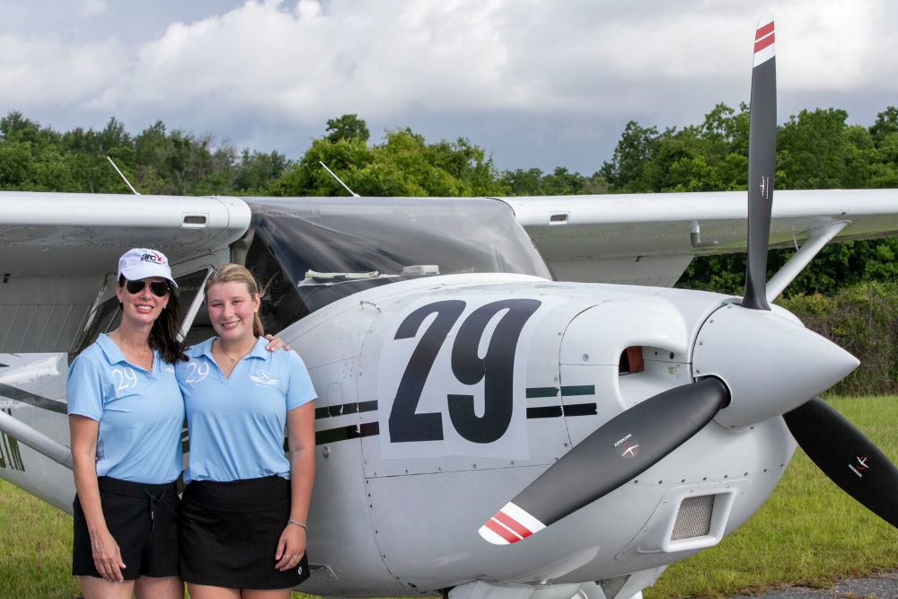 Misty Dyas and Ivy Steiner standing beside their aircraft at the Air Race Classic