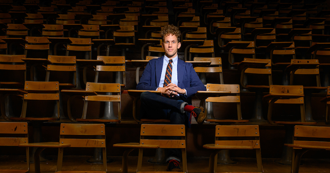 Elijah Gaddis sitting at a desk inside an Auburn University lecture hall