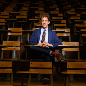 Elijah Gaddis sitting at a desk inside an Auburn University lecture hall