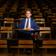 Elijah Gaddis sitting at a desk inside an Auburn University lecture hall