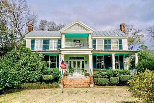 The House on the Hill - a white Civil War era house with green shutters