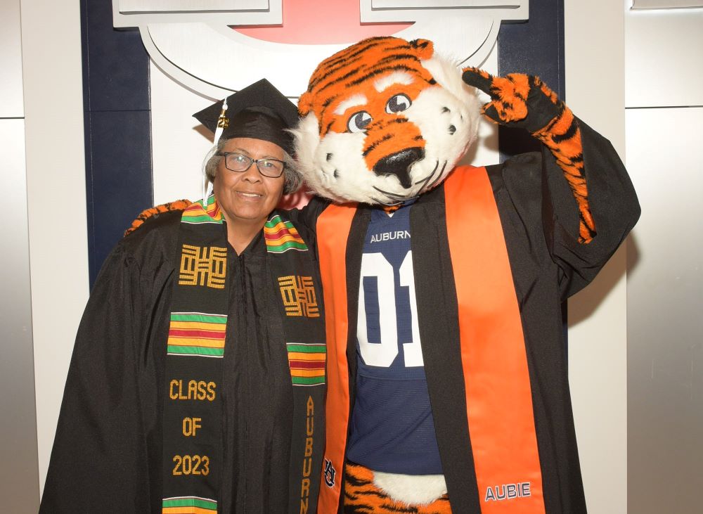 Sherry Potts with Aubie in graduation regalia