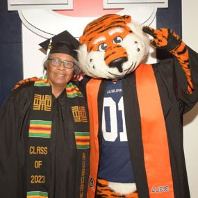 Sherry Potts with Aubie in graduation regalia