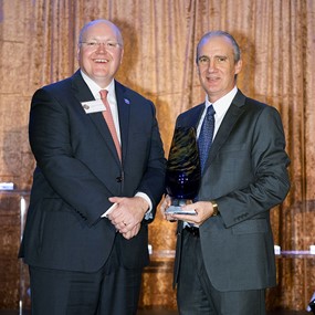 Steve Brown accepting award from Auburn University president Chris Roberts