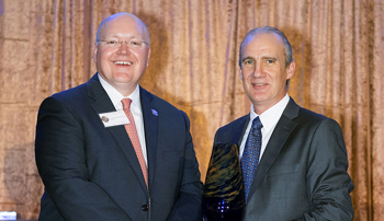 Steve Brown accepting award from Auburn University president Chris Roberts