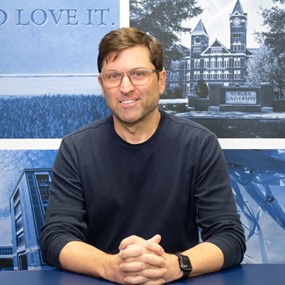 Andy Young sitting at desk in a broadcast center