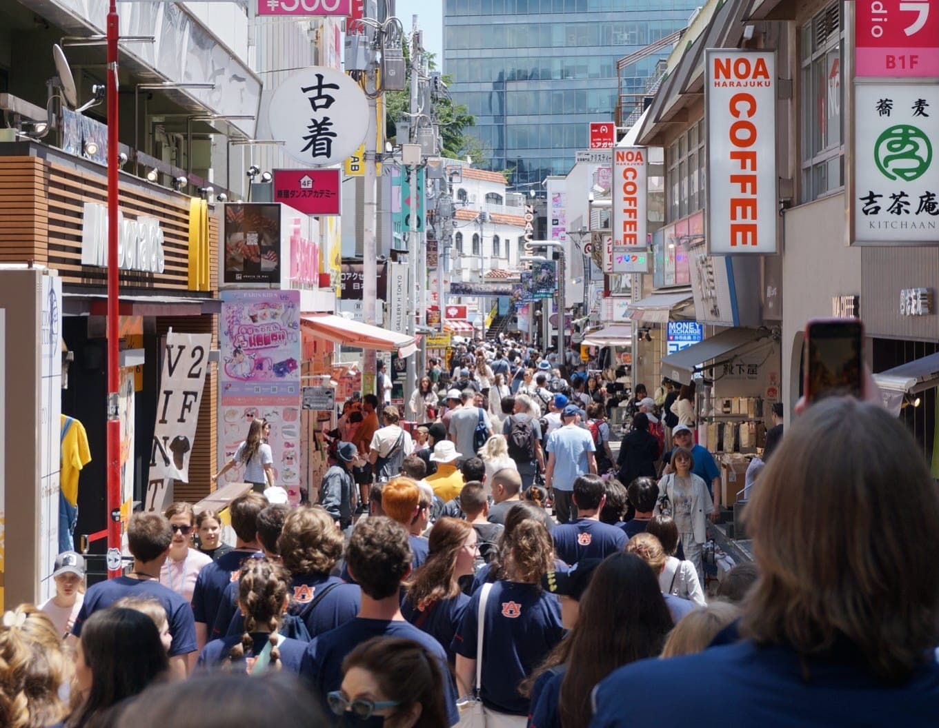Auburn students walking down a busy street in Japan