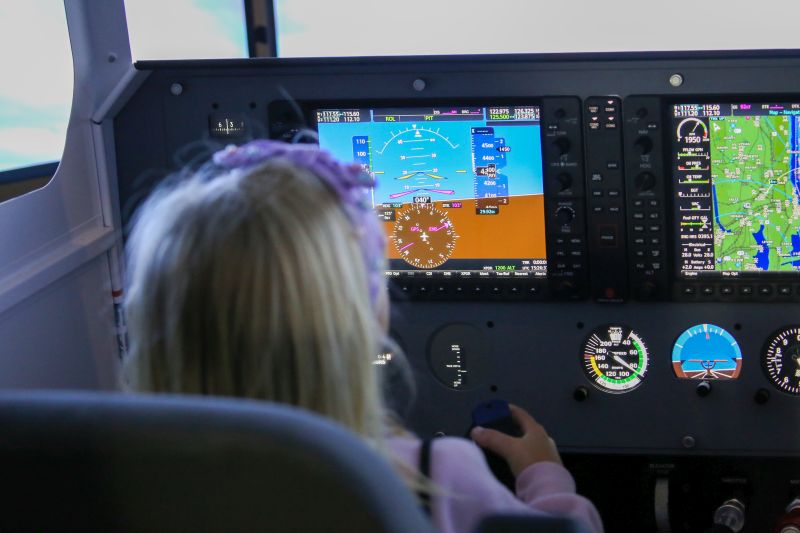 Child sitting in a plane simulator