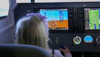 Child sitting in a plane simulator