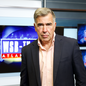 Mark Winne stands in front of WSB-TV monitors