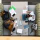 Aerial view of students using various electronic devices to complete coursework