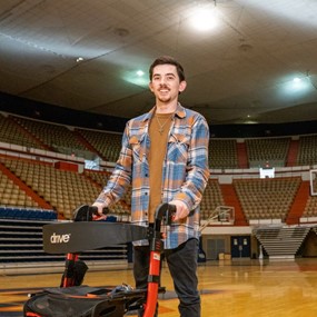 Noah Griffith stands on a basketball court