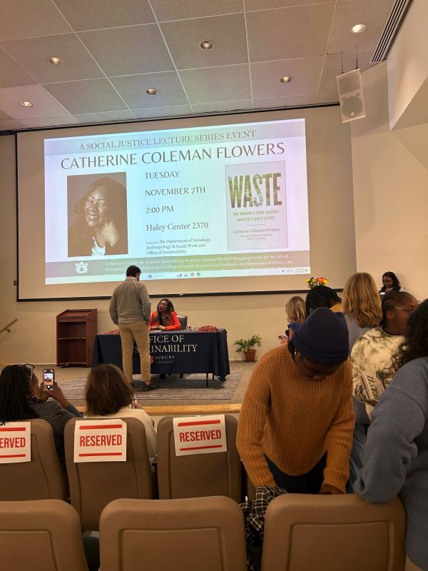 Catherine Flowers signing a book for a student