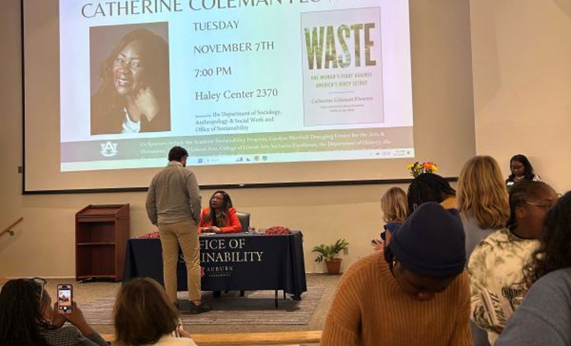Catherine Flowers signing a book for a student
