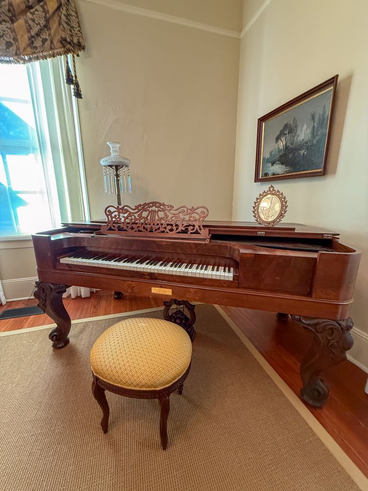 Steinway piano in room furnished with antiques