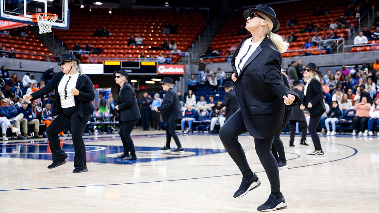 The Recycled TeenAgers performing at an Auburn women's basketball game