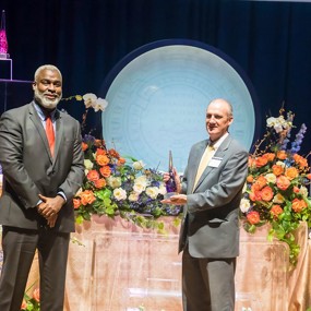 Dr. Steve Brown accepts the Award for Excellence in Faculty Outreach from Dr. Royrickers Cook. 