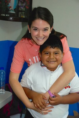 woman hugging a young boy