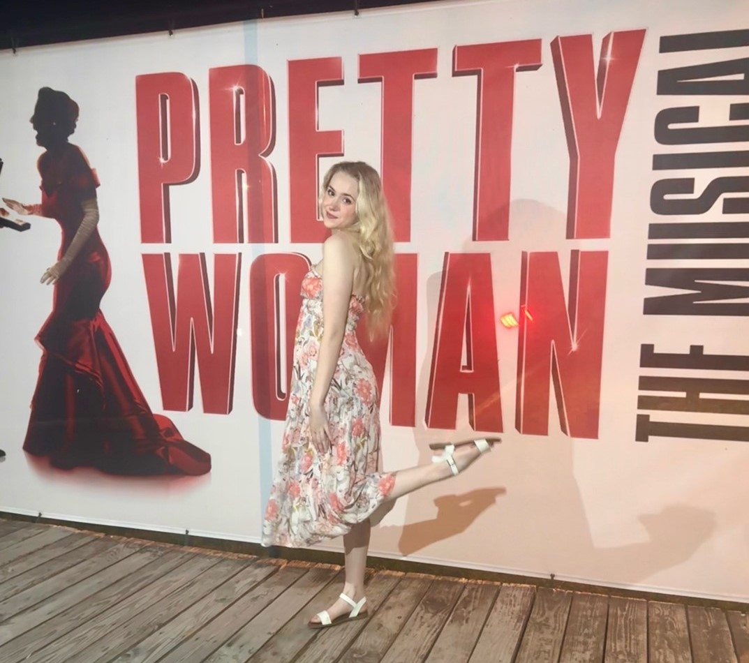 Bethany Novotny posing for a photo in front of the Pretty Woman poster at the Gateway premiere