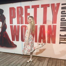 Bethany Novotny posing for a photo in front of the Pretty Woman poster at the Gateway premiere