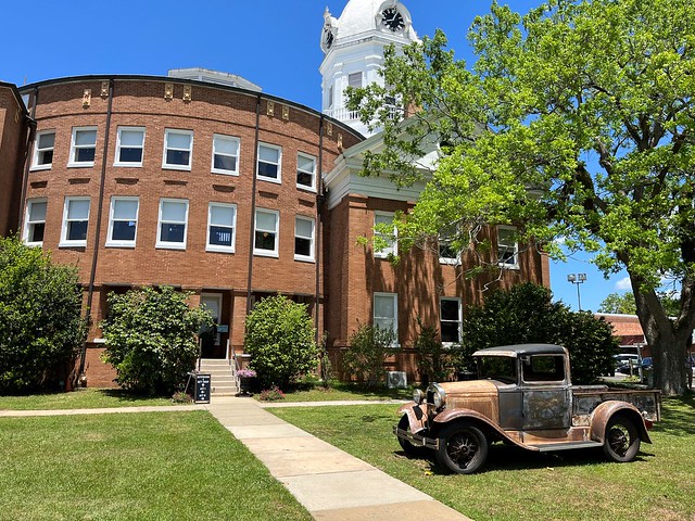 A historic truck parked on the lawn of the Monroe County Courthouse