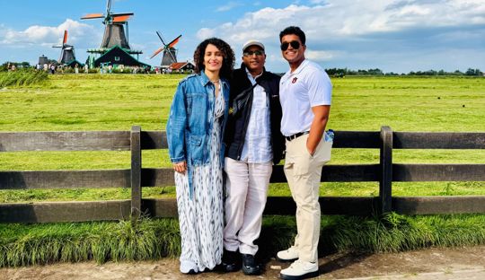 Push Saha and his parents posing for a family vacation photo