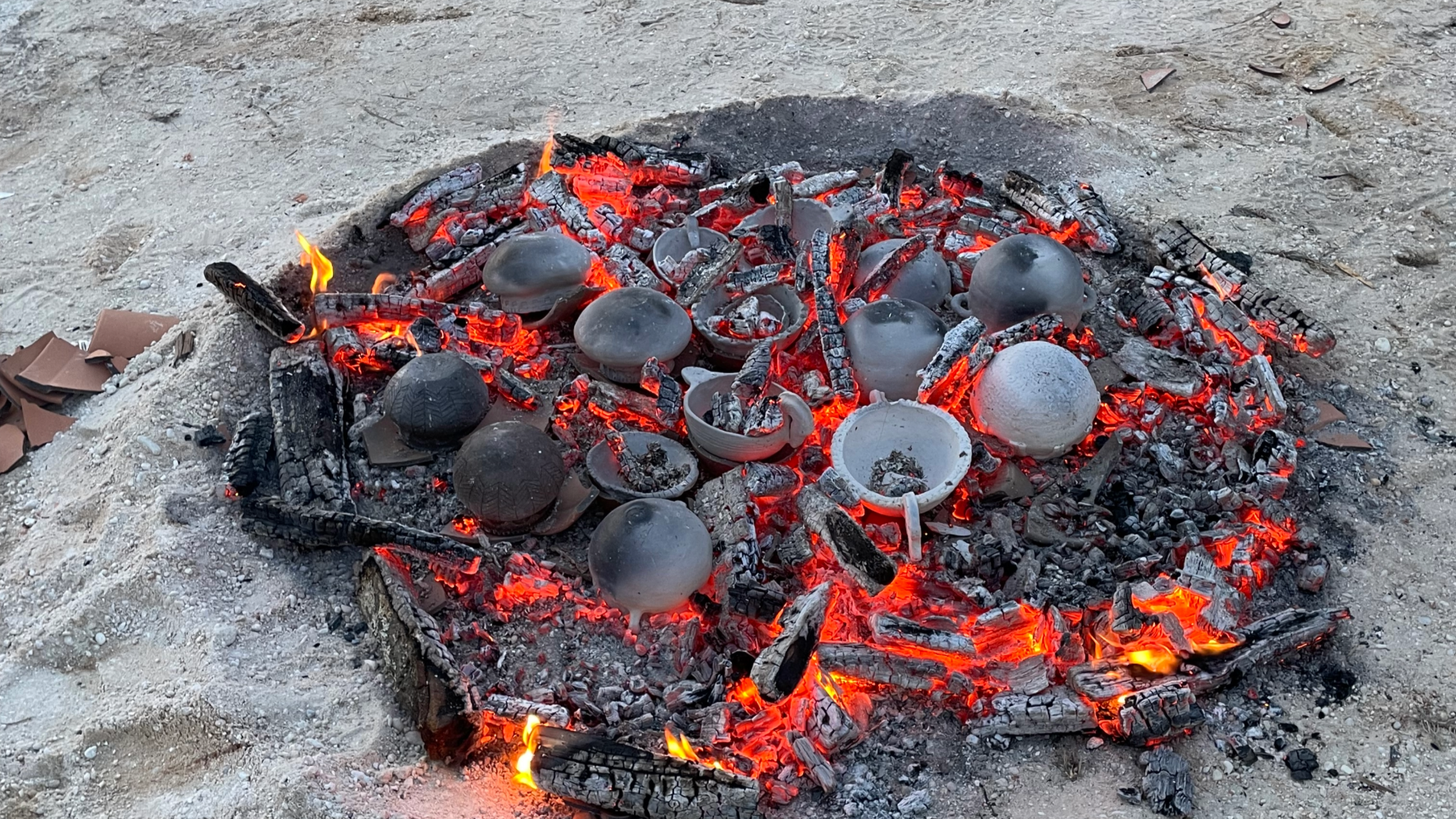 Image of clay pots on top of coals